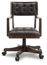 Ashley Furniture Breckington Home Office Set with a desk and matching chair, shown from the front in a modern office setting.