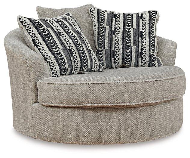 Ashley Calnita living room set featuring a sofa and loveseat with beige upholstery and plush cushions in a modern style.