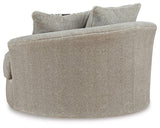 Ashley Furniture Calnita living room set with sofa and armchair, featuring neutral upholstery and modern design.