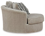Ashley Furniture Calnita living room set with sofa, loveseat, and armchair in neutral fabric, arranged in a modern living space.