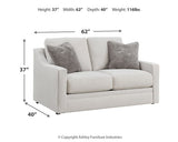Ashley Furniture Maitelynn upholstery living room set with plush sofa and matching armchair, in a modern design.
