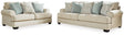 Ashley Monaghan living room set with sofa, loveseat, and armchair in neutral fabric, modern design for cozy family spaces.