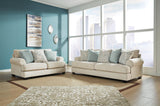 Ashley Furniture Monaghan living room set, includes sofa and loveseat with plush cushions and neutral fabric upholstery.