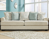 Ashley Furniture Monaghan Living Room Set featuring a sofa and armchair with neutral upholstery and modern design.