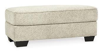 Ashley Monaghan living room set with sofa, loveseat, and armchair in neutral fabric, arranged in a modern living space.