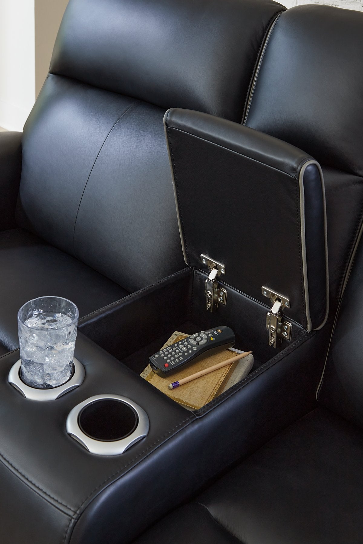 Close-up of the console detail on the Ashley Furniture 5Z-Comfort Power Reclining Living Room Set, showing plush upholstery and stitching.