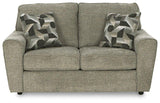 Ashley Cascilla living room set with sofa and armchair in a modern design, featuring neutral upholstery and wooden legs.