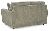 Ashley Furniture Cascilla living room set featuring a sofa, loveseat, and armchair with neutral upholstery and modern design.