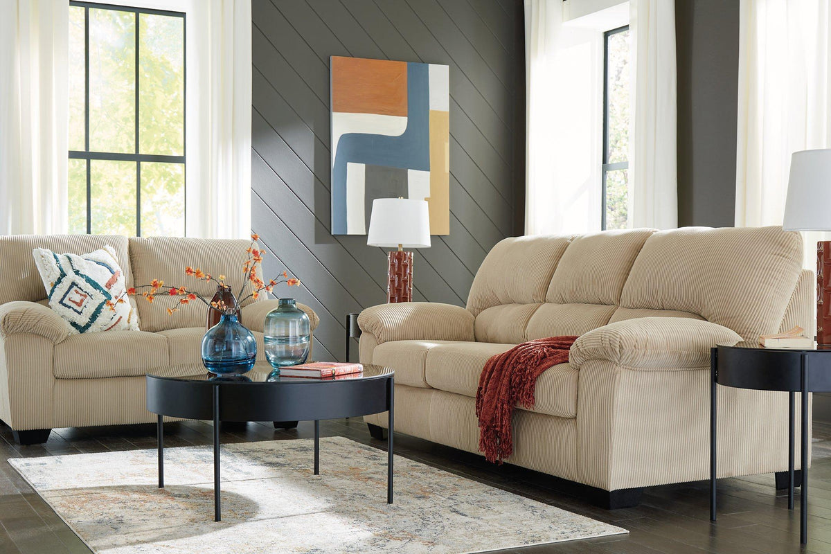 Ashley Furniture SimpleJoy living room set with gray sofa, loveseat, and armchair arranged in a modern living space.