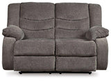 Ashley Tulen Living Room Set featuring a sofa and armchair with neutral fabric and wooden legs in a modern living space.