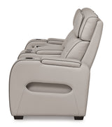 Ashley Furniture Boyington power reclining loveseat with console, showing plush fabric, padded armrests, and built-in cup holders.