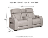 Ashley Boyington power reclining loveseat with console, featuring plush cushions, dark upholstery, and built-in armrest storage.