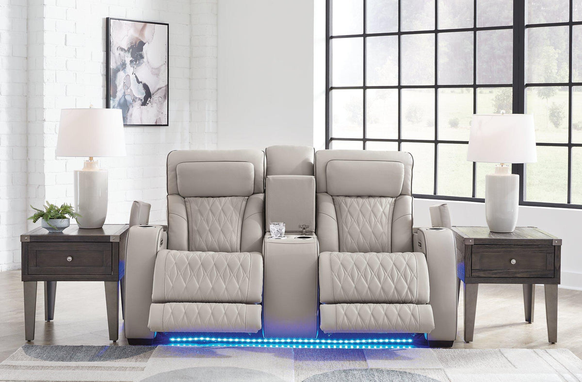 Ashley Furniture Boyington power reclining loveseat with console, featuring plush upholstery and built-in cup holders, in a cozy living room.