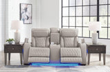 Ashley Furniture Boyington power reclining loveseat with console, featuring plush upholstery and built-in cup holders, in a cozy living room.