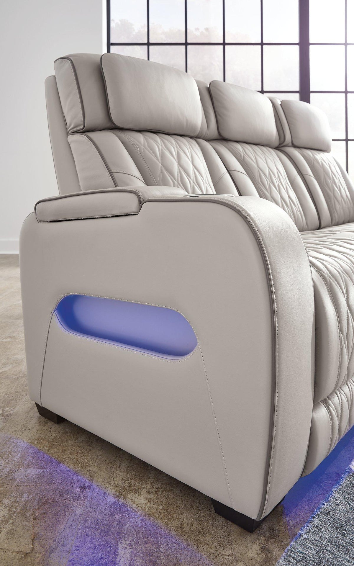 Ashley Boyington power reclining loveseat with console, featuring plush fabric and padded armrests for comfortable seating.