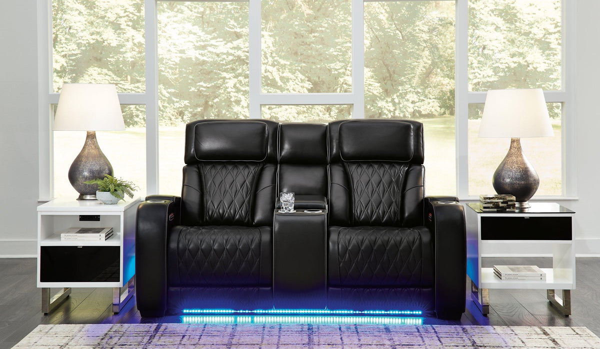 Ashley Boyington Power Reclining Loveseat with Console, featuring plush upholstery, reclining seats, and built-in armrest storage.