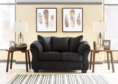 Ashley Furniture Darcy Loveseat with plush fabric and tufted backrest, perfect for cozy living room seating.
