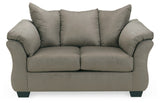 Ashley Furniture Darcy Loveseat with plush fabric and cushioned armrests, perfect for a cozy living room setting.