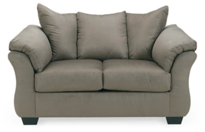 Ashley Furniture Darcy Loveseat with plush fabric and cushioned armrests, perfect for a cozy living room setting.