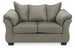 Ashley Furniture Darcy Loveseat with plush fabric and cushioned armrests, perfect for a cozy living room setting.