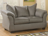 Ashley Furniture Darcy Loveseat with plush fabric and cushioned backrest, perfect for cozy living room seating.