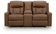 Ashley Furniture Mackmenville reclining loveseat with console, featuring plush fabric, padded armrests, and built-in cup holders.