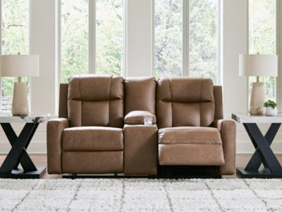 Ashley Furniture Mackmenville reclining loveseat with console, featuring plush cushions and built-in drink holders, in a cozy living room setting.