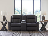 Ashley Furniture Mackmenville reclining loveseat with console, featuring plush fabric and built-in cup holders, in a cozy living room setting.
