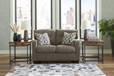 Ashley Mahoney loveseat with plush fabric and cushioned seats, perfect for cozy living room seating.