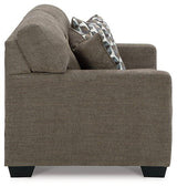 Ashley Mahoney loveseat with plush fabric and cushioned arms, perfect for cozy living room seating.