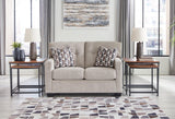 Ashley Mahoney loveseat with plush fabric and cushioned arms, perfect for cozy living room seating.