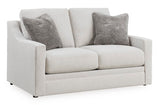 Ashley Furniture Adda Loveseat with plush cushions and modern design, shown from an angled view.