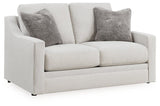 Ashley Furniture Adda loveseat in a cozy fabric with plush cushions, shown from an angled view.