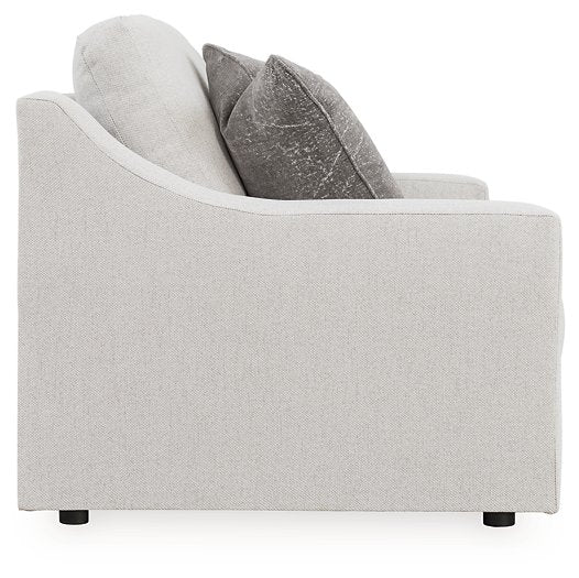 Ashley Furniture Adda Loveseat with plush fabric and cushioned armrests, shown from a side angle.