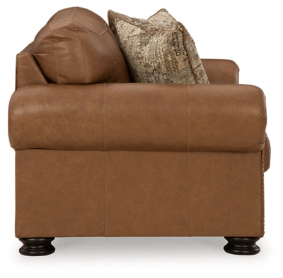Ashley Furniture Carianna loveseat with plush fabric and rolled arms, shown in a cozy living room setting.