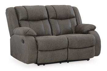 Ashley Furniture First Base Reclining Loveseat with plush cushions and reclining features in a modern living room setting.
