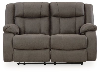 Ashley Furniture First Base reclining loveseat with plush cushions and reclining features, shown in a head-on view.