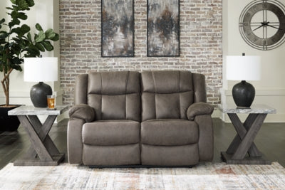 Ashley Furniture First Base reclining loveseat with plush cushions and fabric upholstery, shown in a closed position.