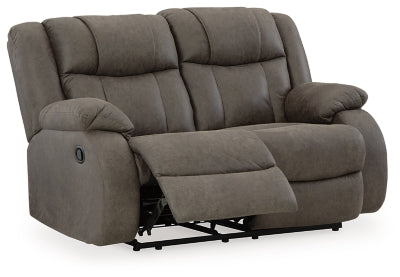 Ashley Furniture First Base reclining loveseat shown from an open angle with plush cushions and reclining feature.
