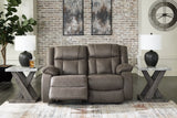 Open Ashley Furniture First Base reclining loveseat with plush cushions and reclining features for comfortable seating.