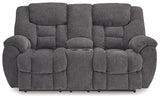 Ashley Furniture reclining loveseat with console, featuring plush cushions, armrests, and built-in cup holders for added comfort.