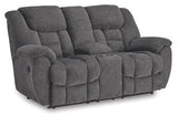 Ashley Furniture reclining loveseat with built-in console, featuring plush upholstery and comfortable armrests.