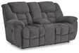 Ashley Furniture reclining loveseat with console, featuring plush upholstery and built-in cup holders for comfort and convenience.