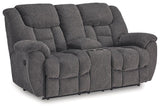 Ashley Furniture reclining loveseat with console, featuring plush upholstery and built-in cup holders for comfort and convenience.