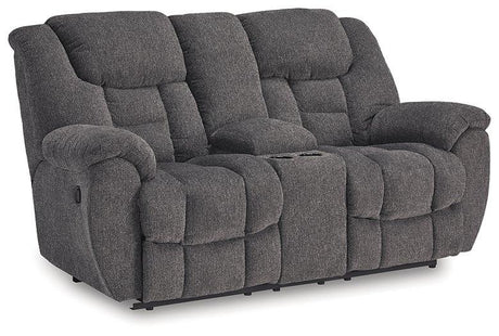 Ashley Furniture reclining loveseat with console, featuring plush upholstery and built-in cup holders for comfort and convenience.