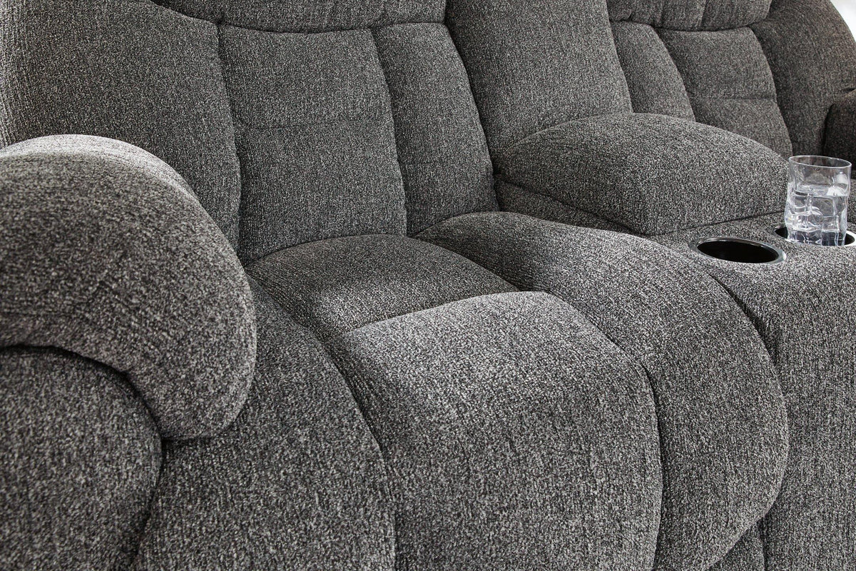 Ashley Furniture Foreside reclining loveseat with console, showing plush fabric, padded armrests, and built-in cup holders.