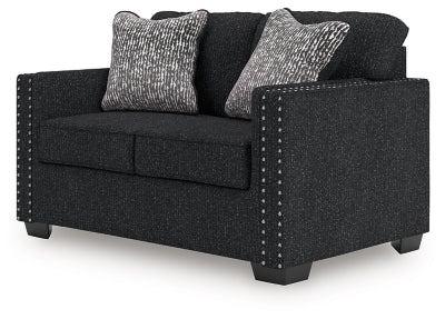 Ashley Furniture Jasmine Peaks loveseat showing plush beige fabric, cushioned armrests, and stylish design from an angled view.