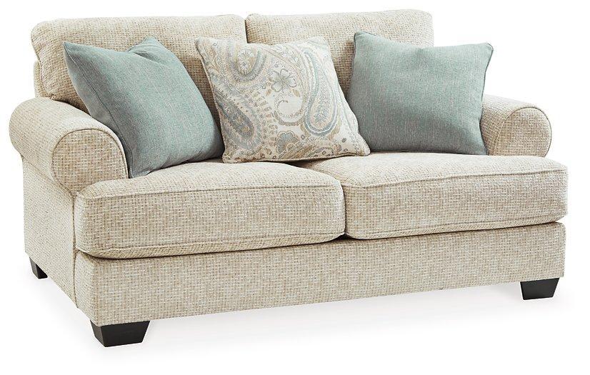 Ashley Monaghan Loveseat with plush fabric and cushioned arms, perfect for cozy living room seating.