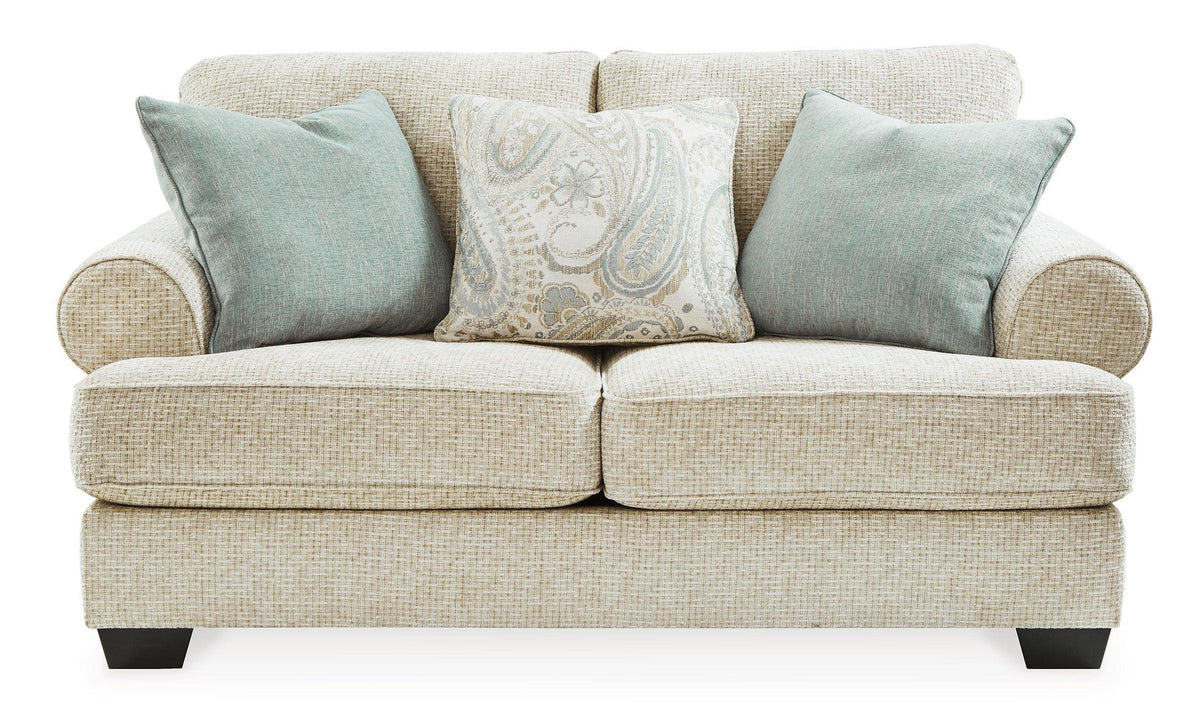 Ashley Furniture Monaghan loveseat with plush fabric and cushioned armrests, perfect for living room comfort.