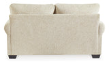 Ashley Monaghan loveseat with plush beige fabric and cozy cushions, perfect for small living rooms or cozy seating areas.